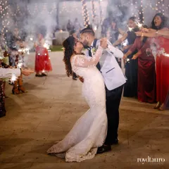 The first kiss as a married couple, surrounded by the sparkle of fireworks held by their friends and family. A truly magical and celebratory moment.
