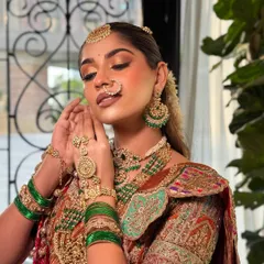 Adjusting the jewellery is part of the process. The makeup is designed to harmonize with the heavy, intricate gold jewellery, creating a balanced and stunning look.