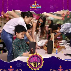 At our Diwali Mela, children get hands on with festive crafts. Here, a little one is deeply focused on creating a beautiful piece of art to take home, a perfect memento from a day of celebration.
