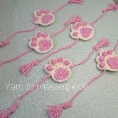 For the sibling who loves animals. This is my paw print rakhi, featuring a cute pink and white paw design with braided ties and tassels.