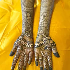 A full-arm bridal design featuring bands of marching elephants, a symbol of good luck and prosperity. The combination of fine lines and bold figures creates a rich texture.