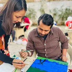 This is what it's all about for me: guiding you through the creative process. Here, I'm helping a participant with their brushwork during a relaxed outdoor painting session. It's not about perfection, but about finding your flow and enjoying the moment.