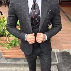 For a bolder look, I can craft suits with distinctive patterns like this charcoal grey suit with a windowpane check. The matching waistcoat and jacket create a cohesive and stylish outfit.