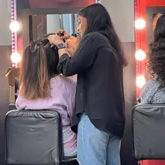 A candid moment from a shoot, where I'm styling hair. Teamwork and a positive attitude are essential for a smooth and successful day on set.