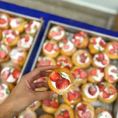 A close-up of my mini strawberry and cream bombolinis, perfect for a party dessert table.