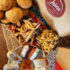 A close-up of our assorted sweets and namkeens. This is just a small sample of the delicious variety you can find at my shop.