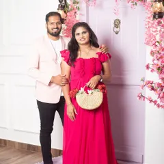 A classic pre-wedding portrait in front of our romantic floral door setup. The couple's coordinated outfits and happy smiles make this a timeless shot.