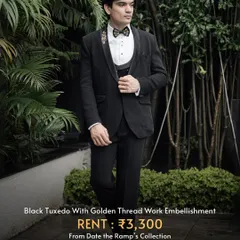A classic black tuxedo with subtle golden thread work on the lapel. It’s a timeless choice that commands attention.