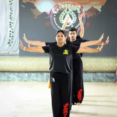 A synchronized group pose, showcasing the harmony and precision we strive for in our practice. This movement requires every person to be present and connected to the group.