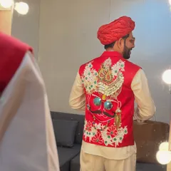 A reflection shot showing the incredible detail on the back of my red Navratri vest. Every outfit is a conversation starter.