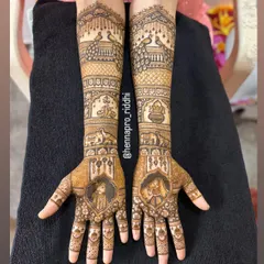 I adore creating full bridal arms with traditional Indian motifs. This design features majestic peacocks, auspicious wedding symbols like the kalash, and portraits of the bride and groom for a classic look.