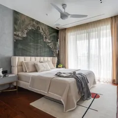 In this master bedroom, I wanted to create a dramatic yet calming focal point. I achieved this with a custom back wall featuring a striking green marble pattern set against handmade flutes. Paired with rich wooden flooring and soft, layered textiles, the room becomes a personal sanctuary that feels both luxurious and deeply restorative.