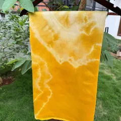 A beautiful silk cotton saree, hand-dyed with marigold petals to achieve this sunny, vibrant yellow. The soft, abstract patterns make it a truly one-of-a-kind piece for any special occasion.
