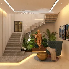 We often create small indoor gardens to bring nature inside. This design utilizes the space under a staircase for a green nook, complete with a Krishna statue, creating a peaceful and spiritual focal point in the home.