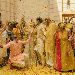 These events are about family and togetherness. I love capturing candid moments of pure happiness, like this one where the entire family joins in the flower shower celebration.