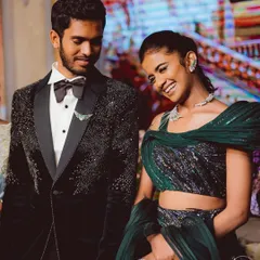 For this Budapest-themed masquerade reception, I styled the couple in elegant evening wear. The groom wears a sparkling tuxedo jacket and the bride a custom emerald green lehenga with unique winged jewelry.