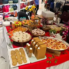 This is a look at a full grazing table I created for a workshop with the Titan group. The setup features a wide variety of snacks, from cookies and sandwiches to mini tarts and bruschetta, all beautifully arranged.