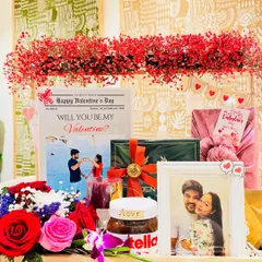 A Valentine's hamper designed for him, because men deserve to be pampered too. This arrangement is bursting with romance, featuring a stunning red floral runner, a personalized newspaper, and a framed photo.