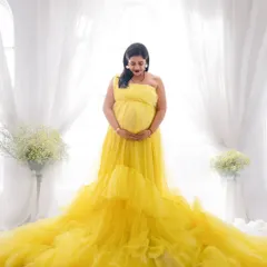 A bright and cheerful portrait celebrating the sunshine you're bringing into the world. This vibrant yellow tulle gown looks stunning against a clean, white backdrop.
