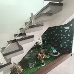 This angle highlights the details of the installation, including the small water feature and the neat edging of the artificial turf.