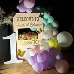 A personalized welcome setup for the butterfly-themed first birthday. We used a custom sign, a large number '1', and a cascade of pastel balloons adorned with little butterflies.