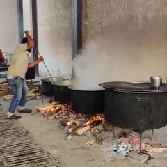 Here is one of my cooks stirring a large degh over a wood fire. This is the authentic, hands-on method I use for all my large-scale cooking.