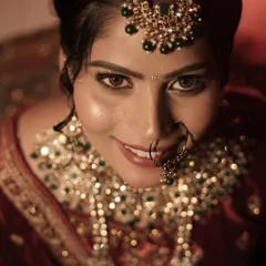 That look of pure happiness. This is a close-up of my bride, showing her glowing skin, soft brown smokey eye, and traditional nath. I always make sure my brides feel confident and beautiful.