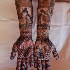 A clear, straight-on view of the finished Shiv-Parvati and Radha-Krishna bridal mehendi, showing the rich stain and intricate details.