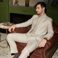 Power and style meet in this custom pinstripe suit, tailored from breathable Irish Linen. It's designed not just for the boardroom but for any setting where making a strong, elegant impression is key. The fit is relaxed yet structured.