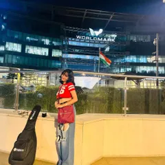 Standing outside Worldmark, Aerocity with my guitar case after a day of music. Being a gigging musician in the city is an adventure.