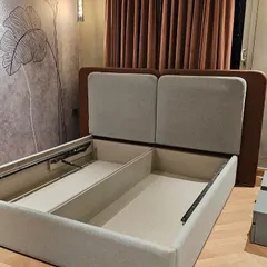 My hydraulic beds are a game-changer for storage. This design features a dual-tone upholstered headboard and a powerful lift-up mechanism, revealing a huge amount of organized space for your linens and extra items.