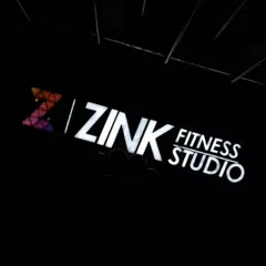 Our Zink Fitness Studio logo lit up in the dark. It’s a beacon for health, happiness, and a premium fitness experience.