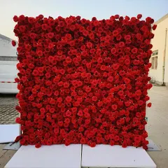 A full, dense wall of artificial red roses. This versatile backdrop can be used to create a dramatic and romantic atmosphere for engagements, anniversaries, or a modern Ganpati setup.