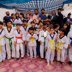 The team celebrates a group victory at the 1st Strike Inter-Club Taekwondo Tournament.