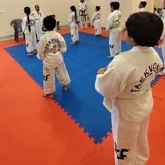 Our students line up for instruction, learning the importance of order and respect in the dojang.