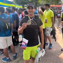 Holding my finisher's medal after a tough race. This is the feeling of accomplishment I help my clients achieve.