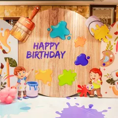 A close-up of the personalized birthday backdrop for an Art theme party. Featuring cute illustrations, 3D paint splatters, and a rustic wooden finish, it's the perfect spot for birthday photos.