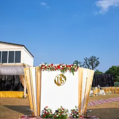 This photo shows how a custom monogram can become a stunning piece of event decor. The 'TS' monogram I designed was crafted into a large, golden centerpiece for this outdoor wedding backdrop, surrounded by beautiful floral arrangements.