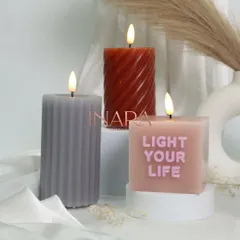 A closer look at some of our new pillar candle designs, including a ribbed texture, a spiral shape, and one with the message 'Light Your Life'.