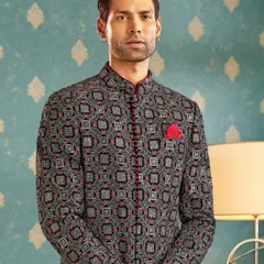Bold patterns meet timeless charm in this statement bandhgala. We designed this piece with intricate geometric patterns and a sharp red trim to redefine regal elegance for the modern man.