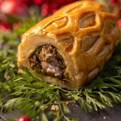 We take pride in creating spectacular centerpiece dishes. Our Holiday Feast's Lamb Wellington, with its golden lattice pastry and rich filling, is a perfect example of the show-stopping quality we deliver for your special occasions.