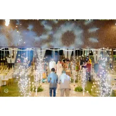 A grand entrance for the couple, complete with cold pyro fireworks lining the aisle. The dramatic lighting and celebratory sparks make for an unforgettable moment.