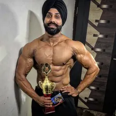 Holding a trophy after a win. This is the goal, to build a physique worthy of first place. I bring this winning strategy to every client's transformation plan.
