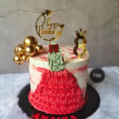 A beautiful cake for an 8th birthday, featuring a figurine of a girl in a stunning red ruffled dress. The red and white marble effect on the buttercream adds a touch of modern artistry.
