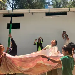 In a powerful simulation, children practice how to rescue a bird entangled in manja kite string. This activity highlights a real-world local danger and empowers them with the knowledge to help.