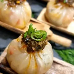 Crystal Veg Dim Sum topped with sizzling chilli oil. These delicate dumplings are a favourite from our Asian menu, perfect as a passed canapé for any event.