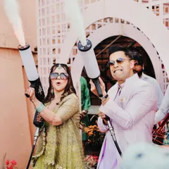 A fun-loving couple makes a grand entrance at their Mehendi with CO2 jets, showing how I incorporate high-energy, modern elements into traditional functions.
