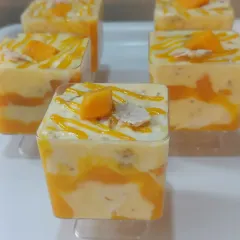 My Mango Eton Mess is a delightful mix of textures. I layer chunks of fresh mango, crunchy meringue pieces, and light cream for a refreshing and completely vegetarian dessert jar.