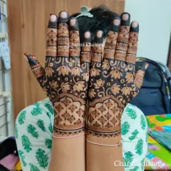 A fancy lotus design that fills the entire hand. The use of negative space around the flowers makes the pattern pop, creating a bold and beautiful statement.