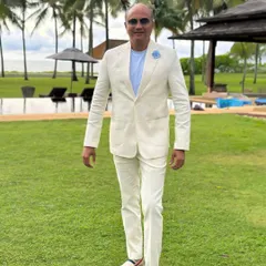 Another shot of the client in the off-white linen suit, walking with confidence. The relaxed tailoring and lightweight fabric make it ideal for warm climates.